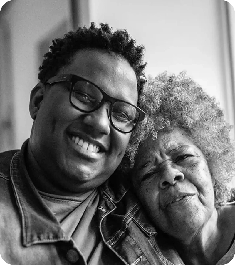 People smiling with an elderly person.